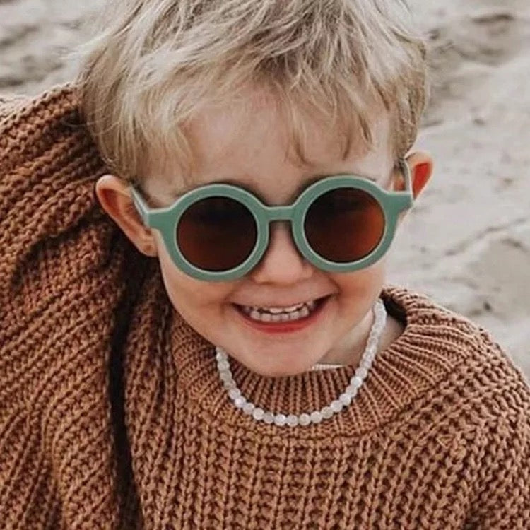 Toddler Wearing Teeny Jade Green Baby Sunglasses UV400Toddler Wearing Teeny Chocolate Baby Sunglasses UV400