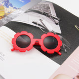 Teeny Ruby Baby Toddler Floral Sunglasses on a Magazine UV400