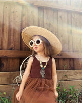 Girl on a Chair Outside Wearing Teeny Burnt Orange Baby Toddler Floral Sunglasses