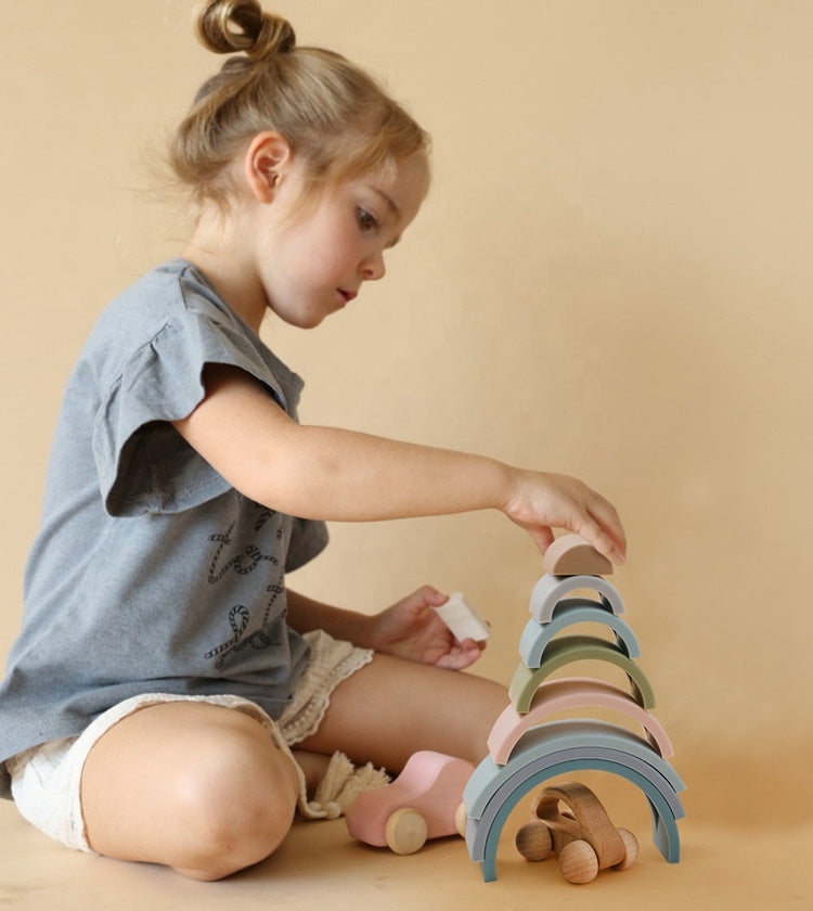 Girl Playing with Montessori Silicone Rainbow Stacking Toy